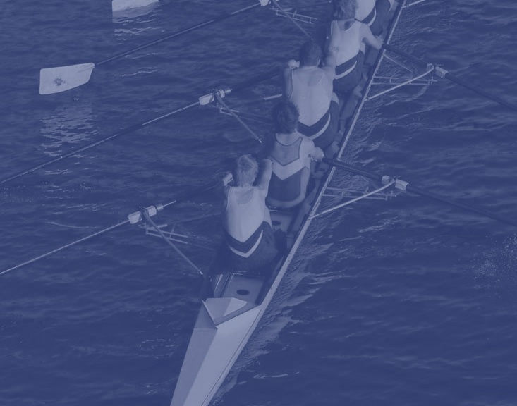 Team members rowing together, representing Syndicare's motto
